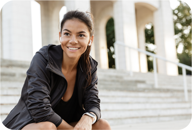 Radiant, athletic woman smiling, exemplifying the positive human health impacts of stem cell therapies.